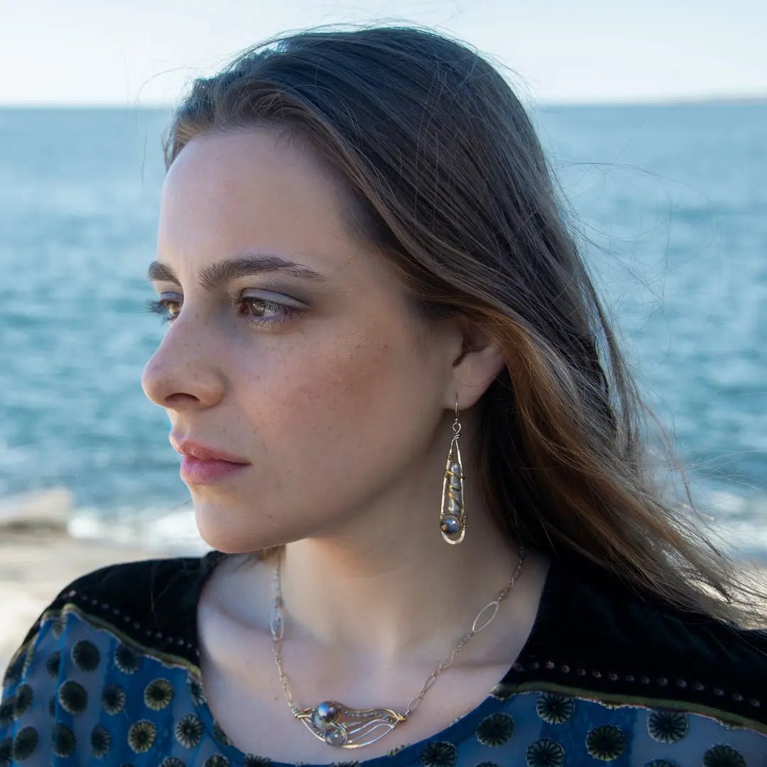 Sterling silver drop earrings with fresh water pearls wrapped in brass wire and crystal disco ball nested in gold filled wire