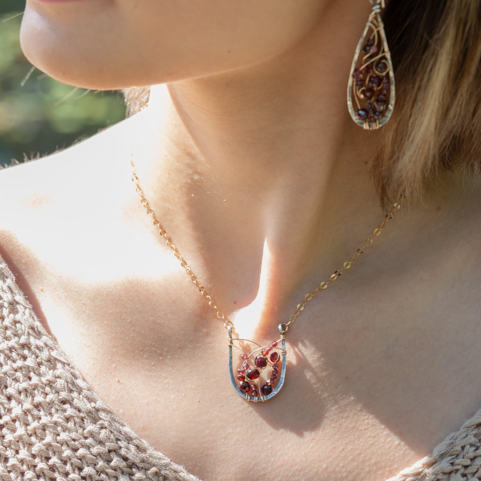 Handmade oxidized sterling silver pendant necklace with faceted garnet gemstones on a gold-filled chain, by Art by any Means Jewelry