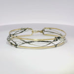 Handmade stamped brass skinny bracelet braided with oxidized sterling silver and gold filled wires