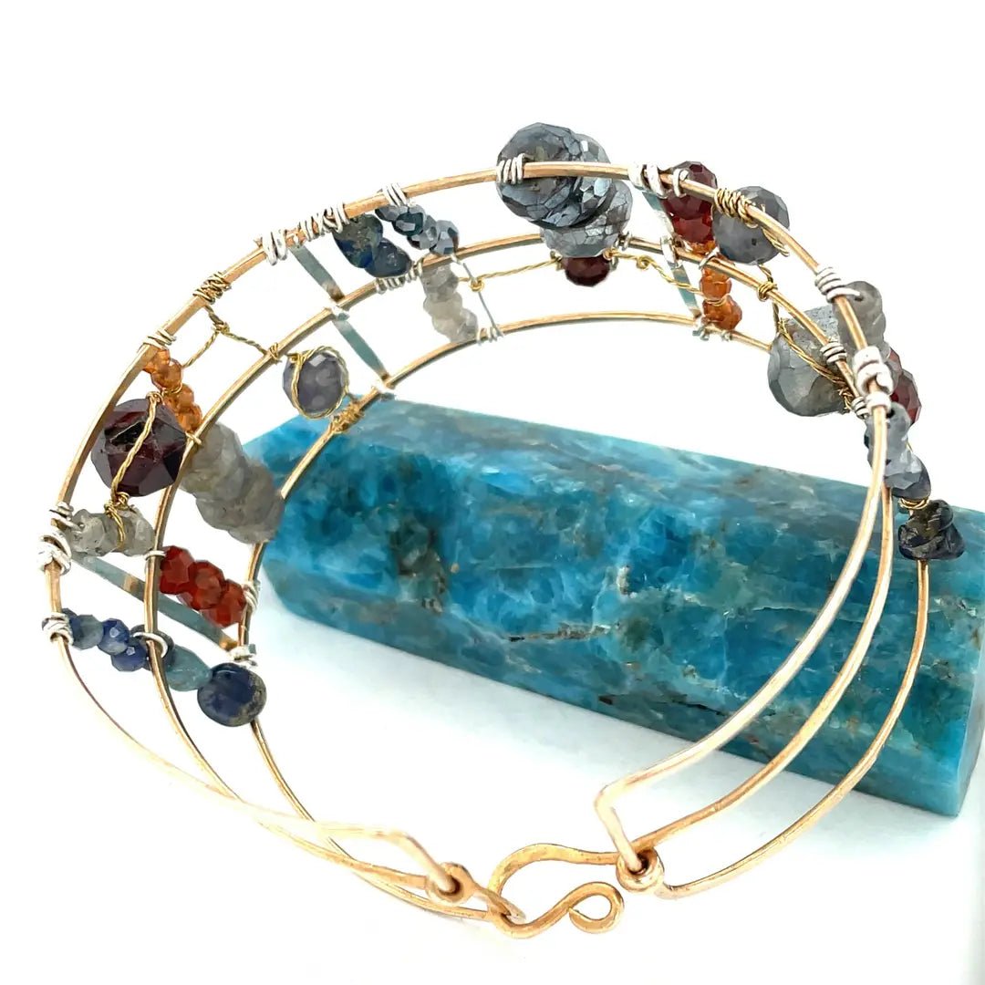 Bronze and sterling silver wide bracelet with labradorite, garnet, iolite, pyrite, and blue opal gemstones with brass accents