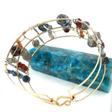 Bronze and sterling silver wide bracelet with labradorite, garnet, iolite, pyrite, and blue opal gemstones with brass accents