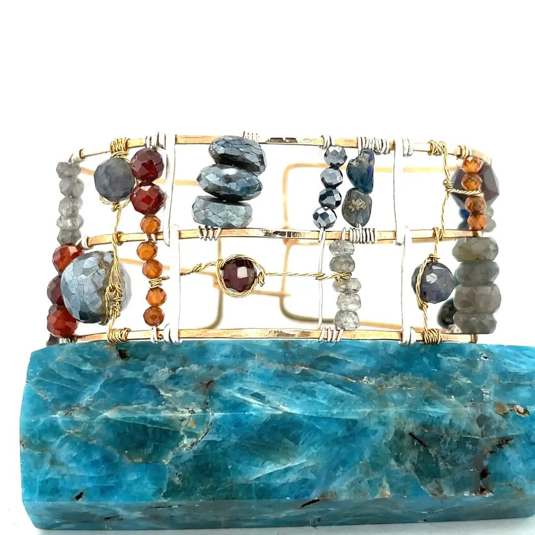Bronze and sterling silver wide bracelet with labradorite, garnet, iolite, pyrite, and blue opal gemstones with brass accents