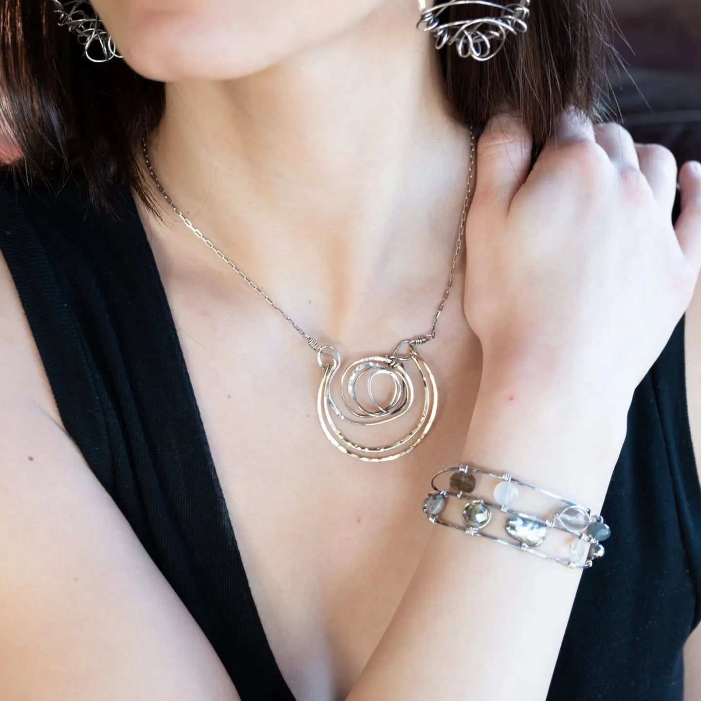 Handmade hammered and darkened sterling silver knot with hammered bronze large arches on sterling silver tube chain necklace