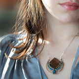 brass pendant necklace, smoky quartz , pyrite, apatite, and chrysocolla, showcased with an oval silver chain and clasp