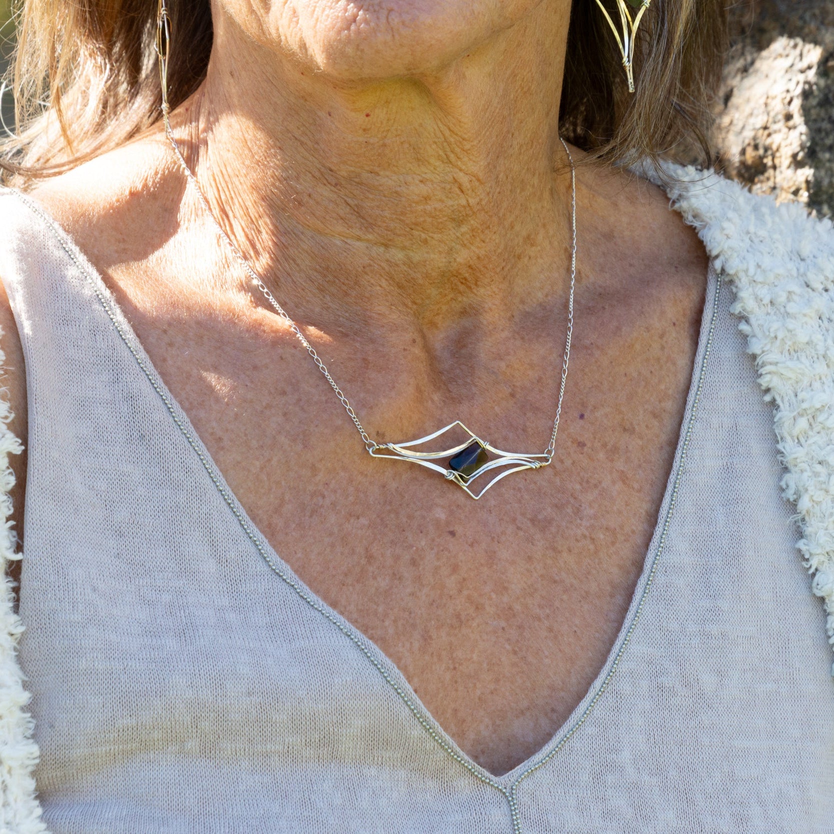 Handmade pendant necklace featuring a smoky quartz gemstone in a spire-cut design, by Art by any Means Jewelry