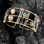 Wide bronze double cuff with sterling silver hammered bars decorated in a plaid pattern with aquamarine, moonstone, labradorite, apatite, and iolite gemstones