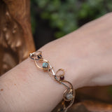 Brass and sterling silver braided bracelet adorned with  flashy labradorite cubes, hessonite garnet, and iolite gemstones