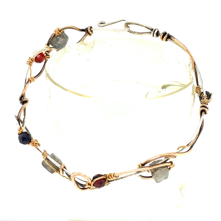 Brass and sterling silver braided bracelet adorned with  flashy labradorite cubes, hessonite garnet, and iolite gemstones
