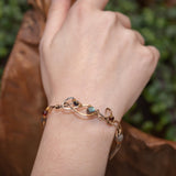 Brass and sterling silver braided bracelet adorned with  flashy labradorite cubes, hessonite garnet, and iolite gemstones