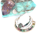 A hand formed bronze and sterling silver pendant necklace with a slide  sterling silver chain, featuring faceted natural tourmaline, green amethyst and flashy labradorite gemstones