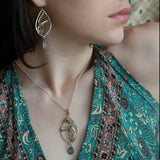 Sterling silver marquise necklace with moss agate and rutilated quartz gemstones in waves of brass and oxidized sterling twist wires