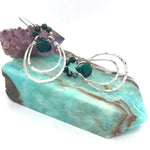 Double sterling silver hoop earrings hanging from bloodstone faceted gemstones with a dark green drop hanging in the center