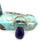 Handmade hammered bronze pendant with built in amethyst nugget, accented with opal and green amethyst on sterling silver wire, featuring a sterling silver chain