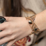 Variety of pyrite gemstones embroider a statement sterling silver handmade cuff bracelet, woven with gold filled and brass twist wires