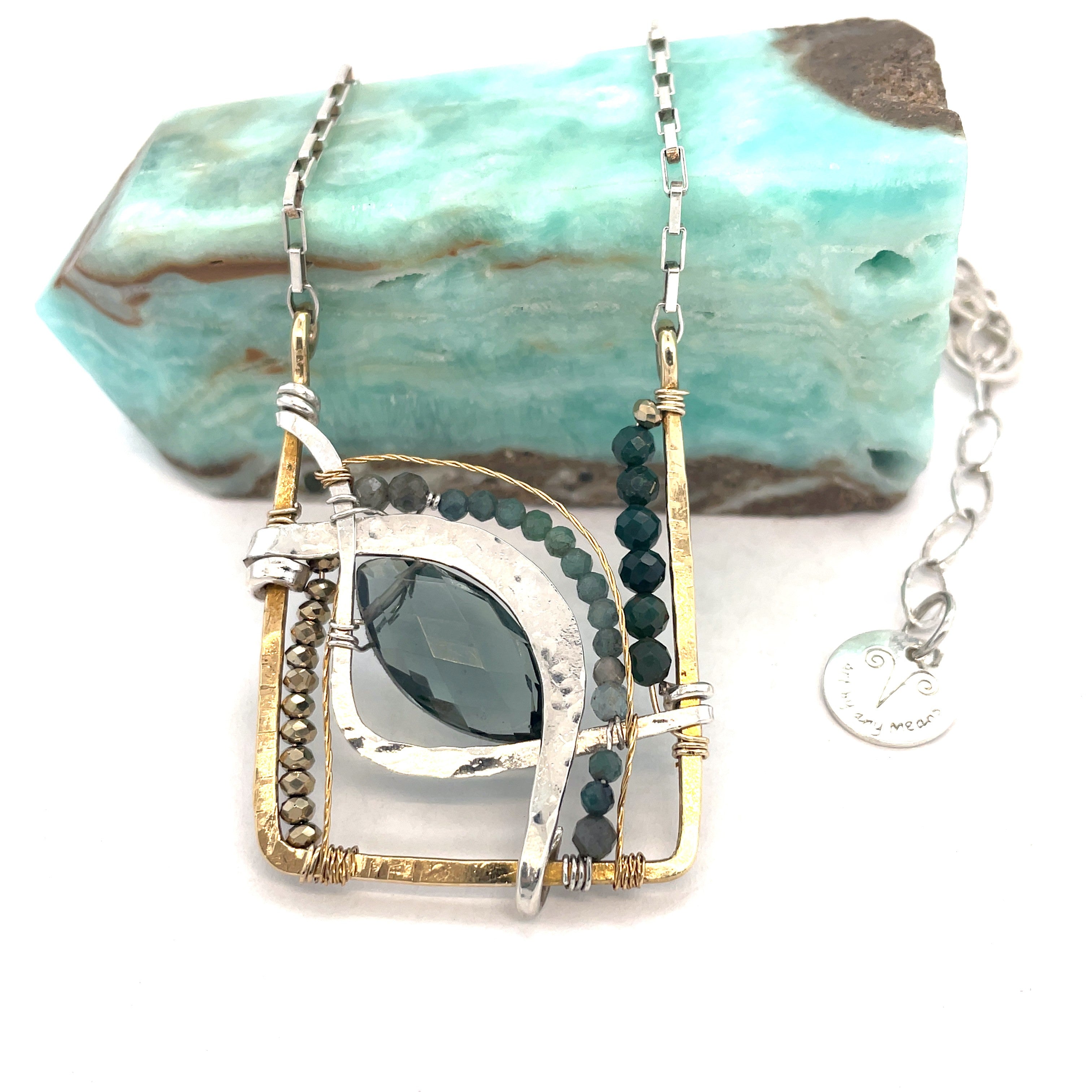 London blue quartz, pyrite, bloodstone, and blue tourmaline gemstones sit within a brass box pendant with sterling silver and gold filled wire accents on a sterling silver box chain