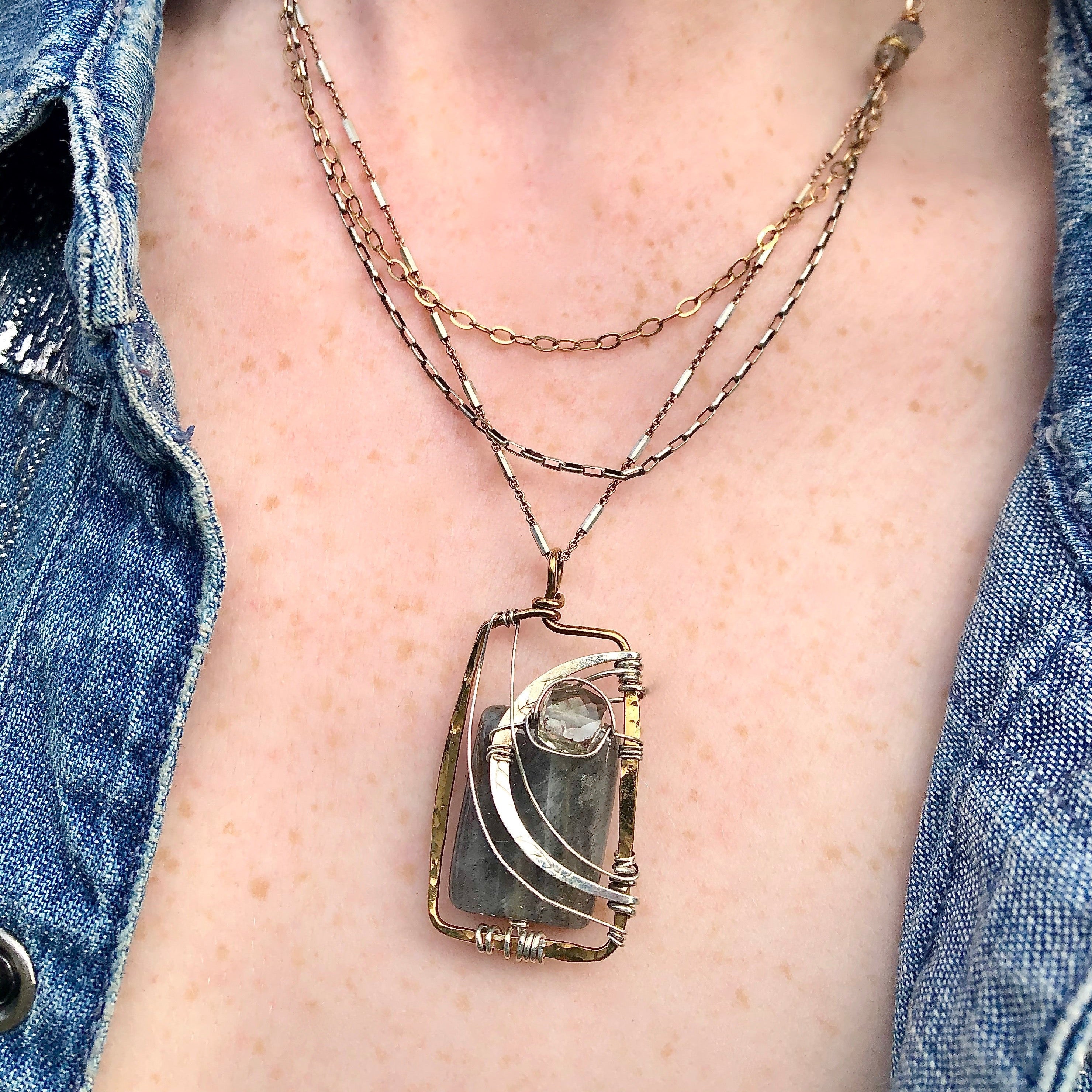 Flashy labradorite smooth rectangle gemstone held in a brass hammered handmade box pendant accented with sterling silver and a faceted green amethyst cube. Necklace features a triple chain, sterling silver and gold filled chains