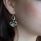 Blue crystal held sideways in a sterling silver fat drop earring with oxidized sterling silver twist wrap