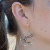 Sterling silver handmade hoop with lavender cubic zirconia stones weaved within brass and oxidized sterling silver twisted wire