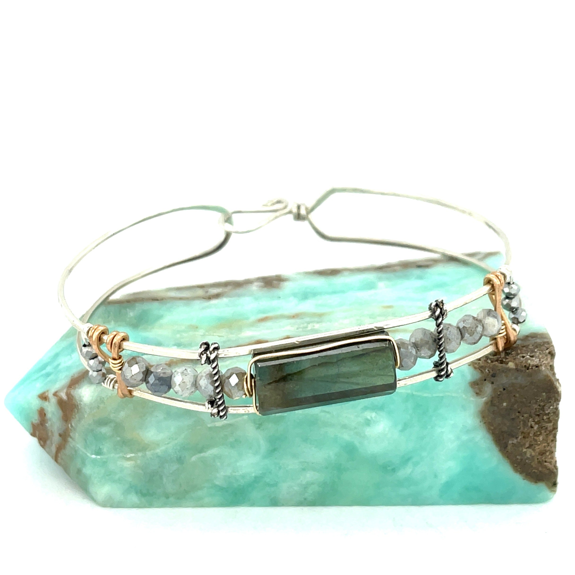 A stackable Labradorite and moonstone gemstone sterling silver skinny bracelet with twisted sterling silver and hammered bronze details