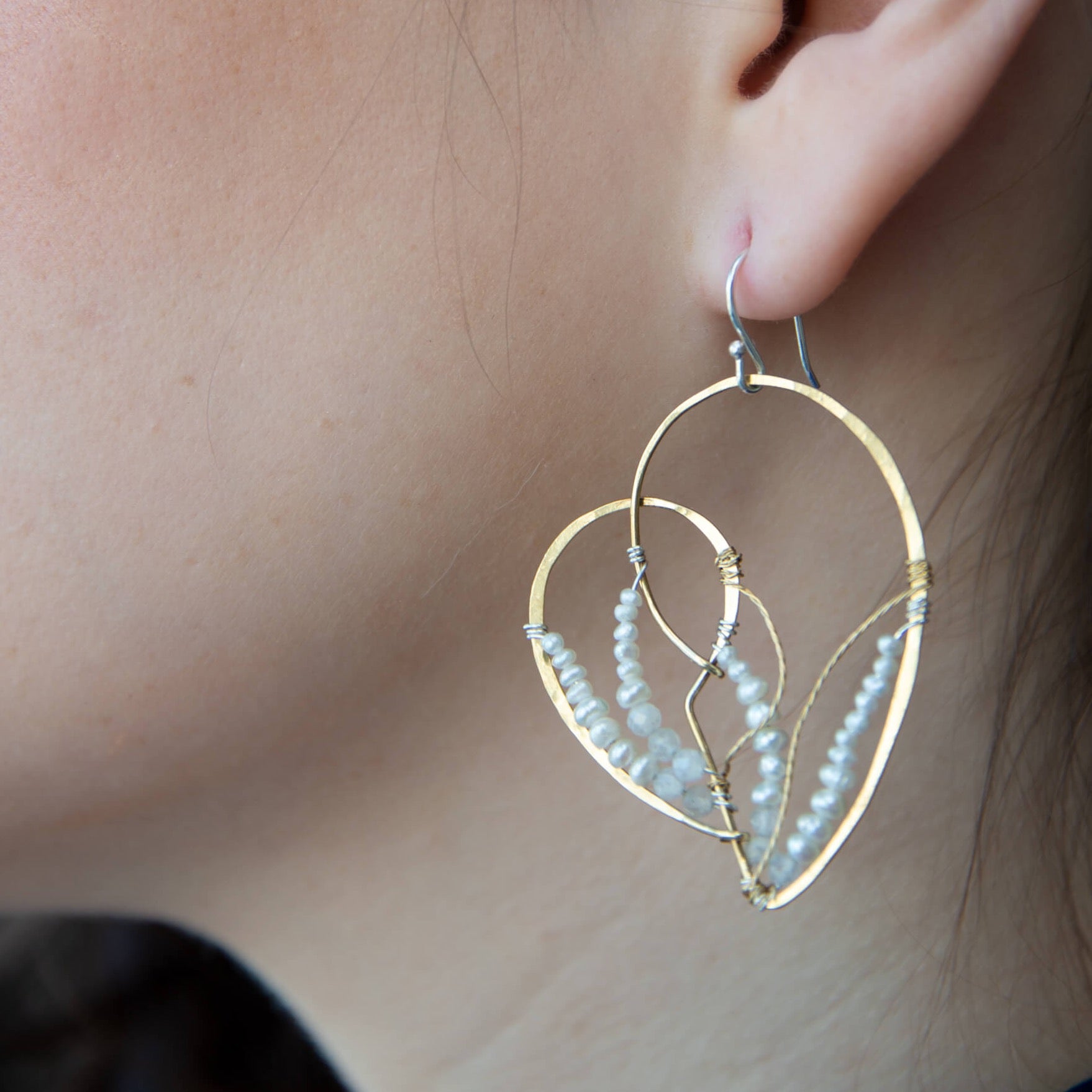 Brass heart shaped statement earring embroidered with tiny fresh water pearls and moonstone gemstones accented with brass twist wire