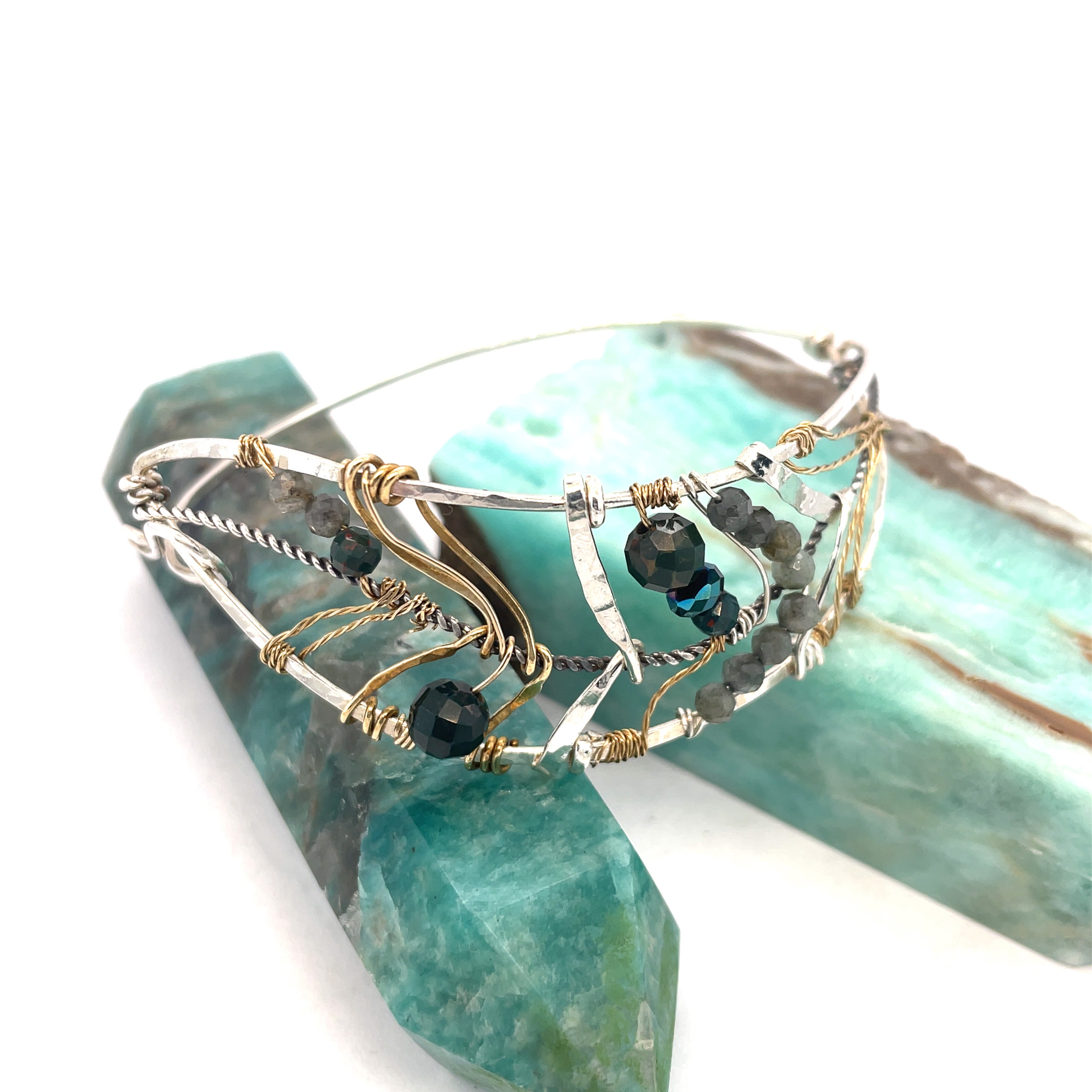 Bloodstone and labradorite faceted gemstones held within a sterling silver hand formed wave bracelet with oxidized sterling twist, gold filled wire and brass accents