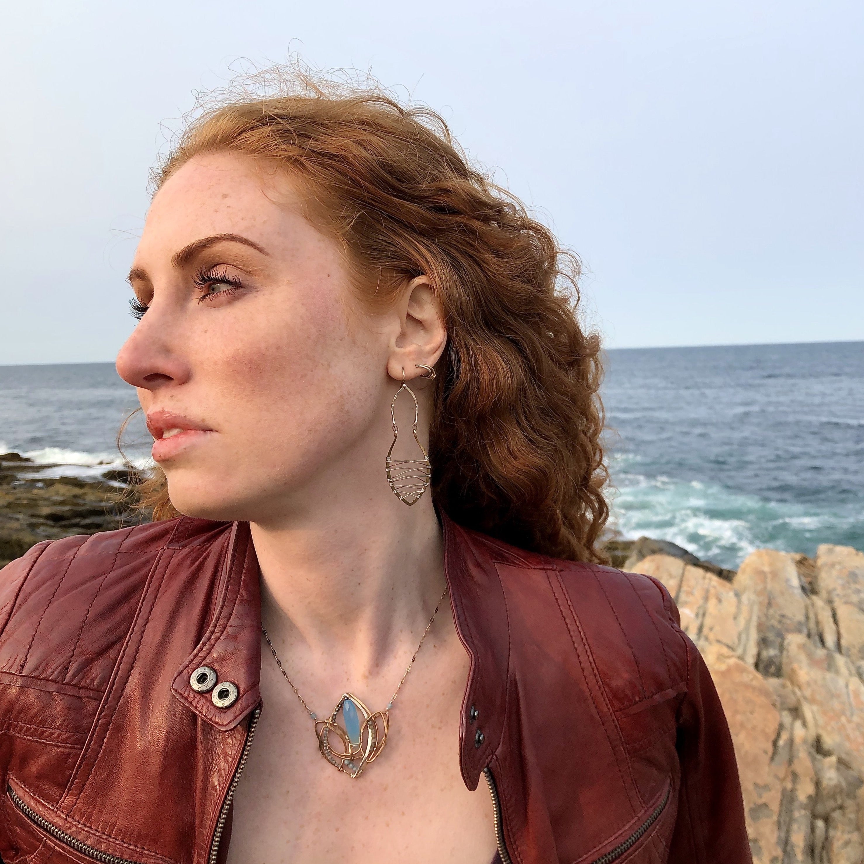 Lotus flower shaped bronze necklace with a large blue chalcedony gemstone point with blue quartz, labradorite, apatite, and sterling silver accents on delicate sterling silver chain