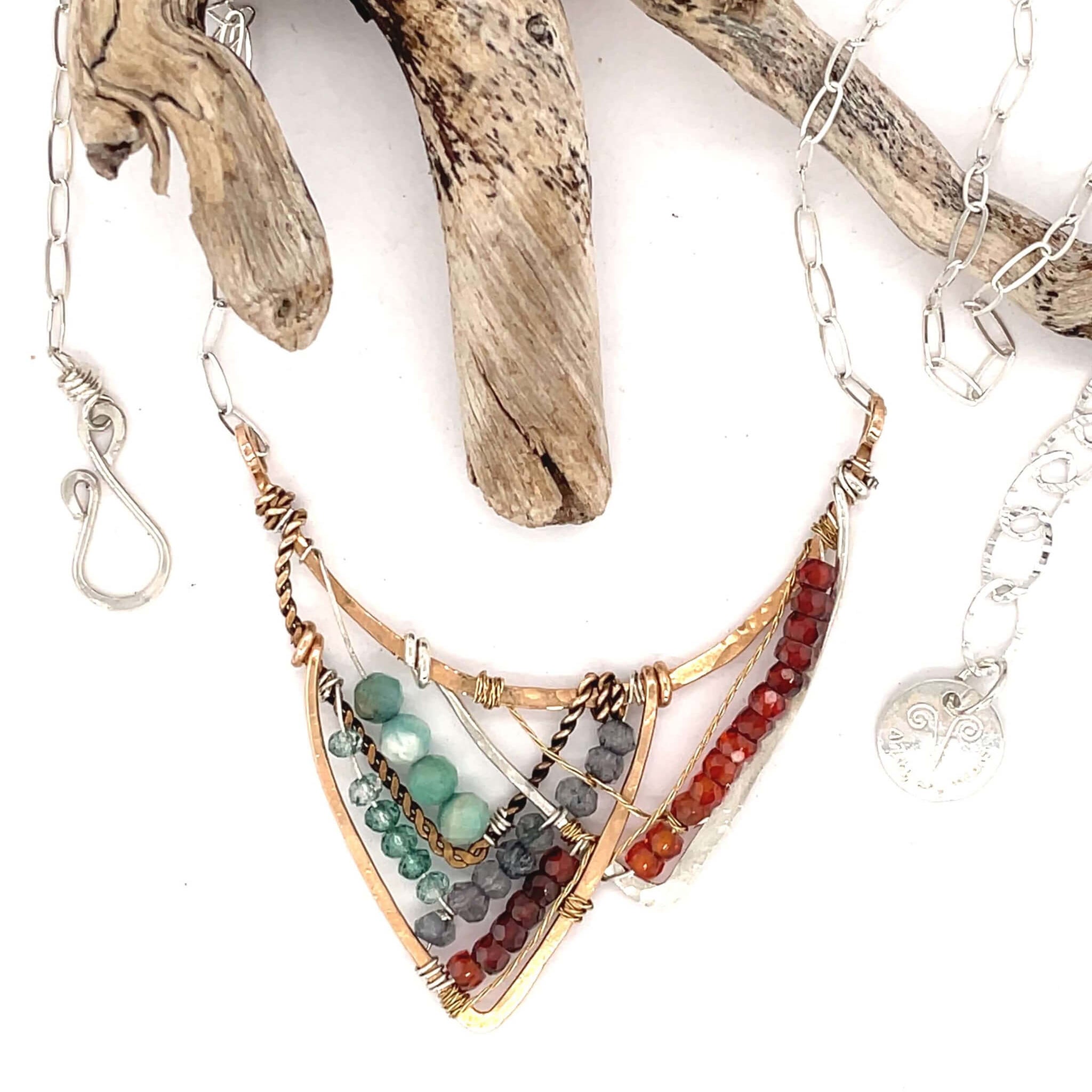 Amazonite, blue labradorite, crystal, and cubic zirconia gemstones all wrapped up within a bronze, sterling silver, and brass twist mountain scape pendant on sterling silver chain