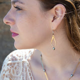 Brass overlapping hammered drops with a singular silver blue fresh water pearl dangle
