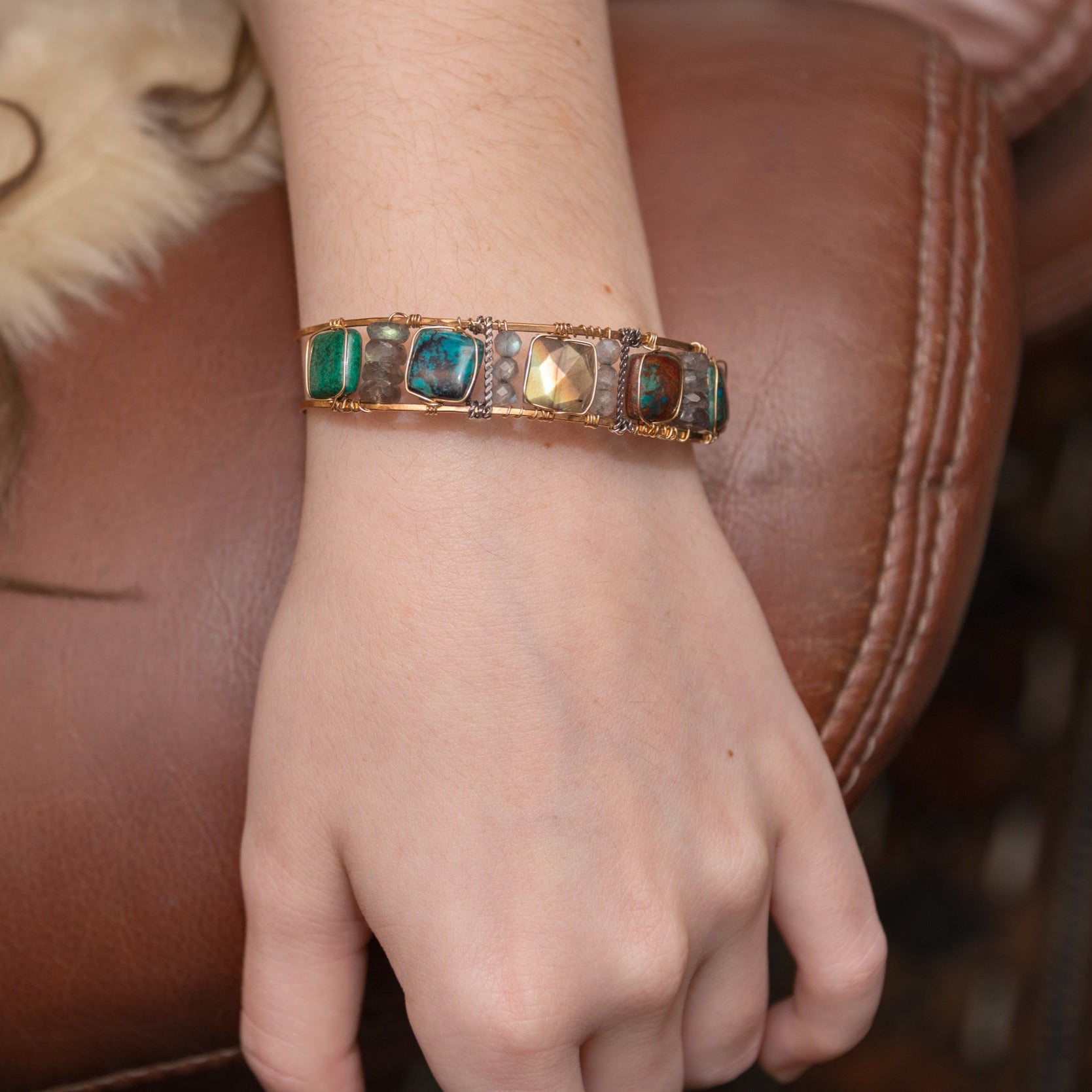 Chrysocolla and flashy labradorite tile gemstones are held within a brass cuff bracelet frame with oxidized sterling silver and gold filled wire accents