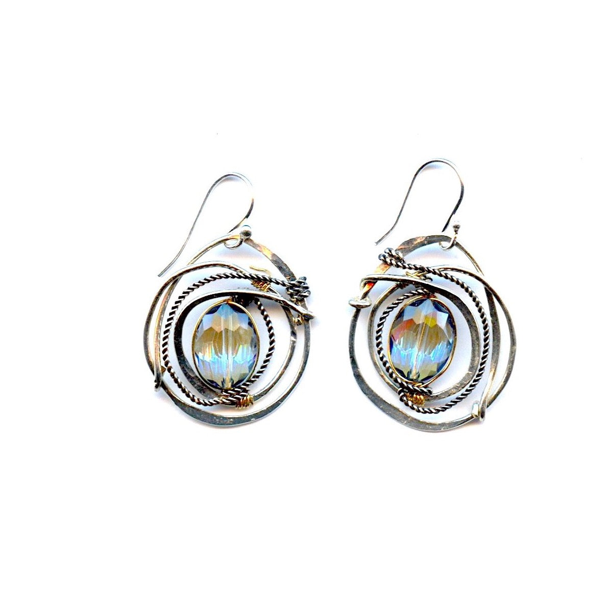 A pair of sterling silver earrings featuring a hammered design with a central blue crystal, edged with oxidized sterling silver twist wire