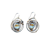 A pair of sterling silver earrings featuring a hammered design with a central blue crystal, edged with oxidized sterling silver twist wire