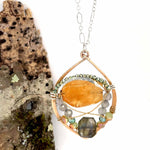 Citrine nugget surrounded by labradorite gemstones and crystal inside a hammered handmade bronze drop necklace with sterling silver and brass twist wire accents