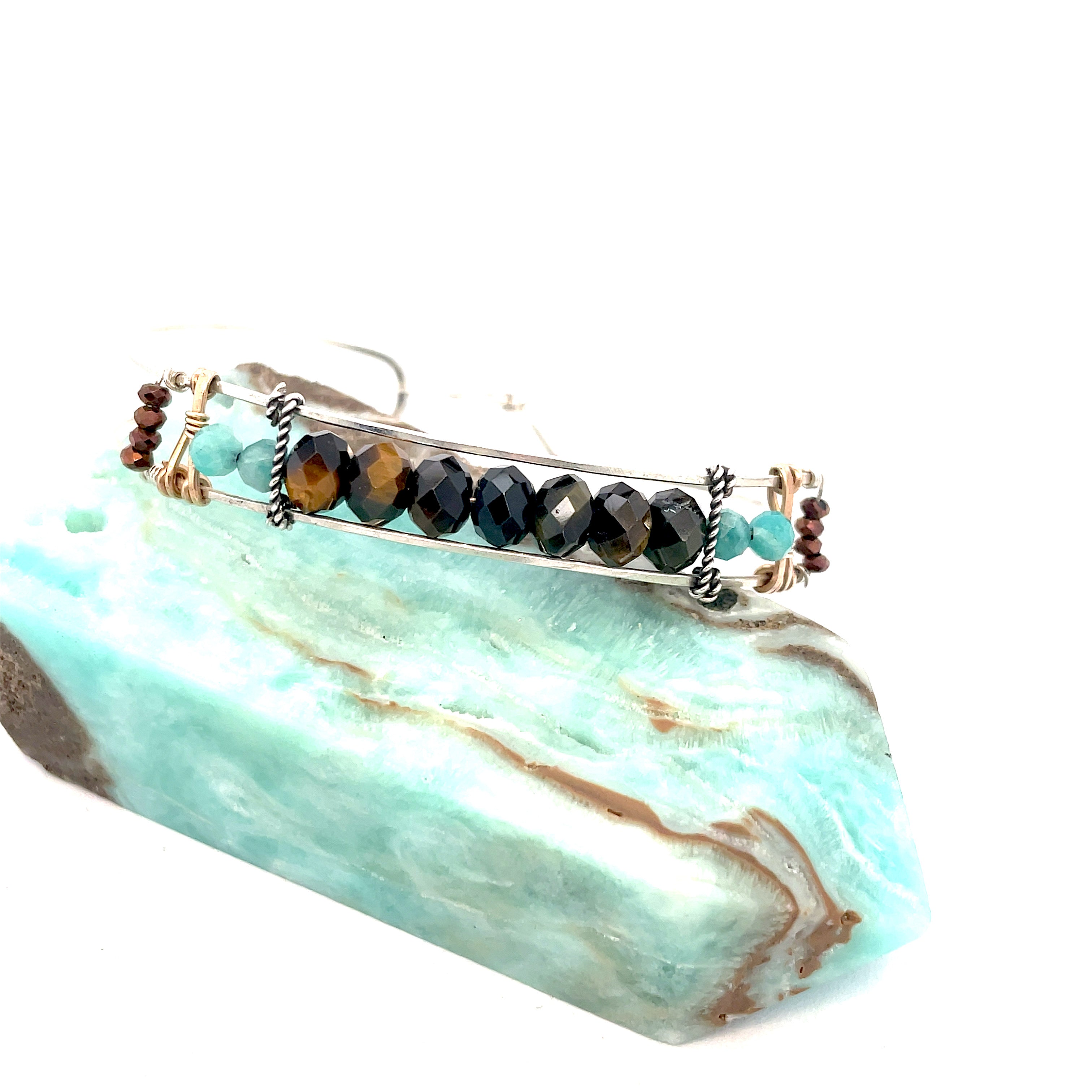 Skinny sterling silver hammered bracelet with faceted tiger's eye, amazonite, and pyrite gemstones, featuring darkened sterling silver twist and bronze hammered accents
