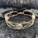 champagne colored faceted crystals held in braided layers of sterling silver, bronze and twisted brass hammered wires all inside a bronze cuff handmade bracelet