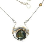 Sterling silver necklace with flashy labradorite drop gemstone and pyrite between swishes of brass wire on a delicate sterling chain with fresh water pearl accents