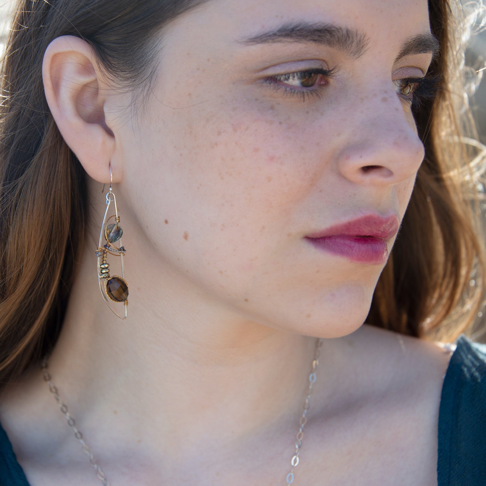 sterling silver dragon fly style earrings with whiskey, smokey quartz gemstones and golden pyrite and crystal accents held within brass twist wire